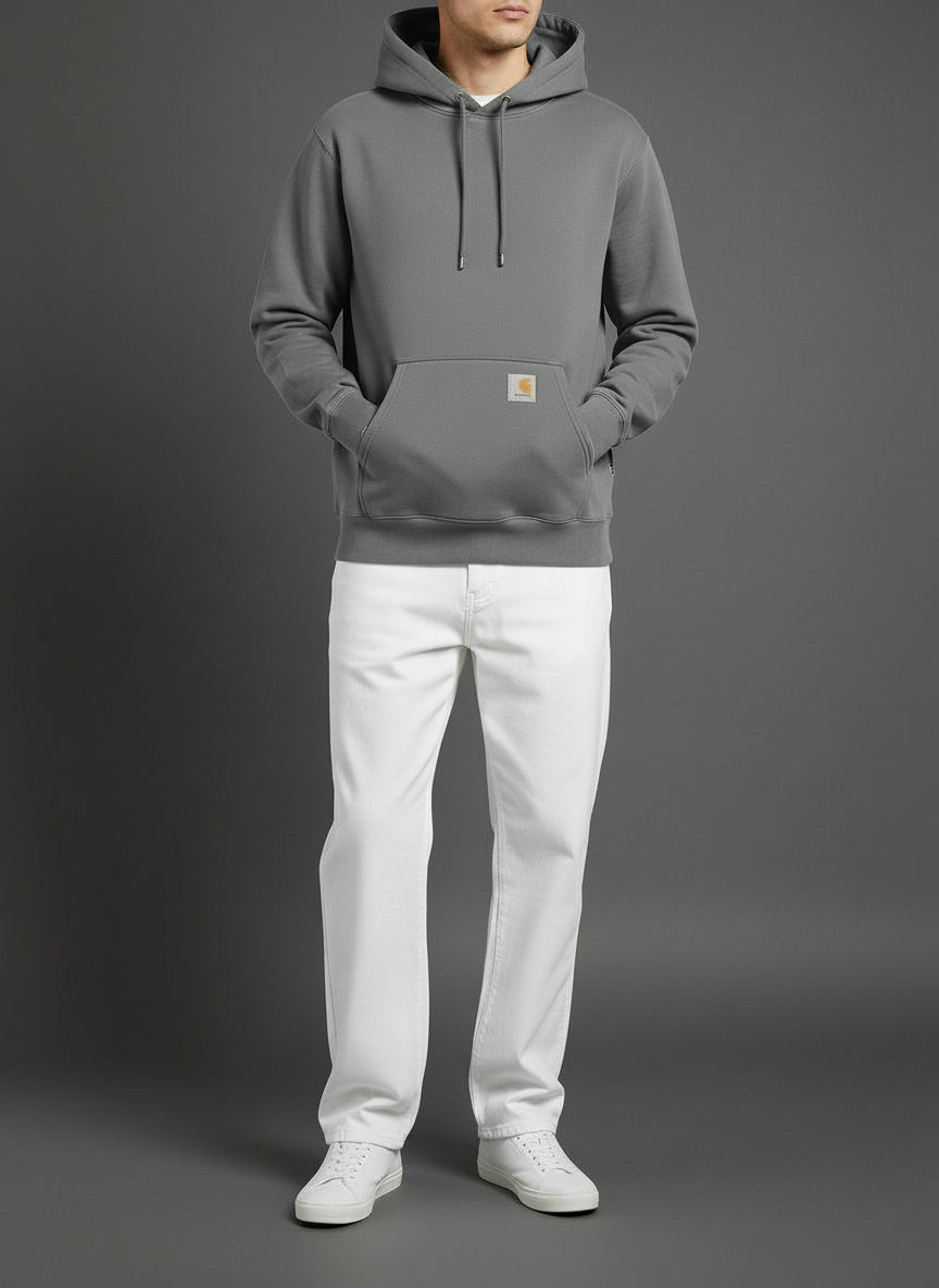 Person wearing a Gray hoodie and white pants on a gray background