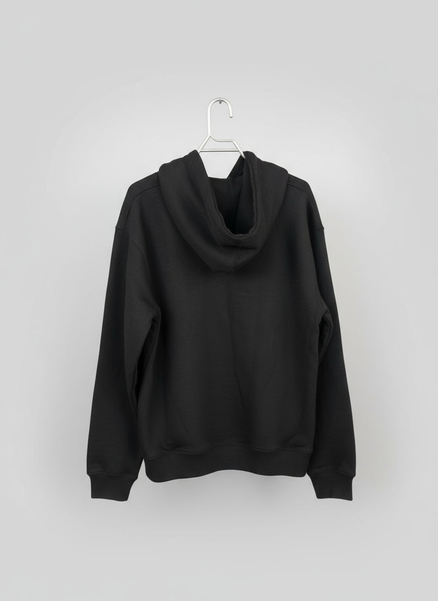 Dark hoodie on a hanger against a neutral background