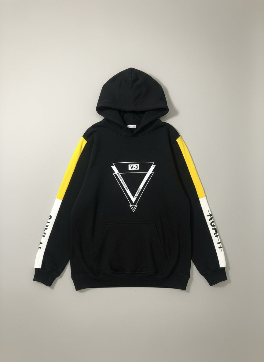 Black hoodie with yellow and white side panels on a textured surface